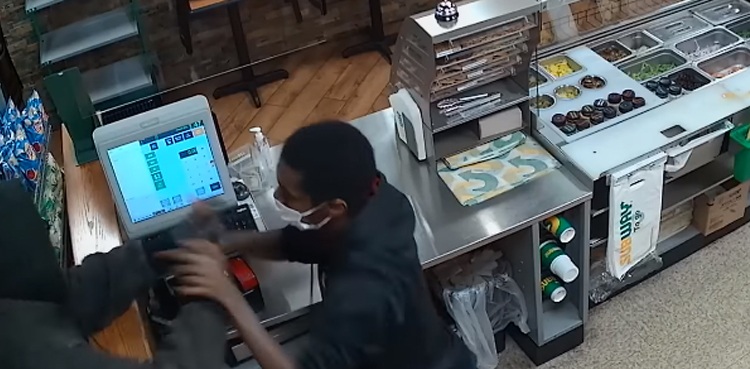 employee robbery suspect fight cctv footage