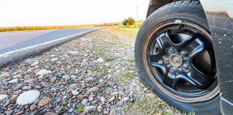car thief teenager changing flat tyre
