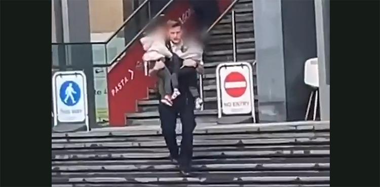 cop, rescues, children, train station fire