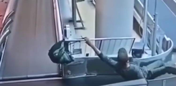 viral video man conveyor belt ride airport