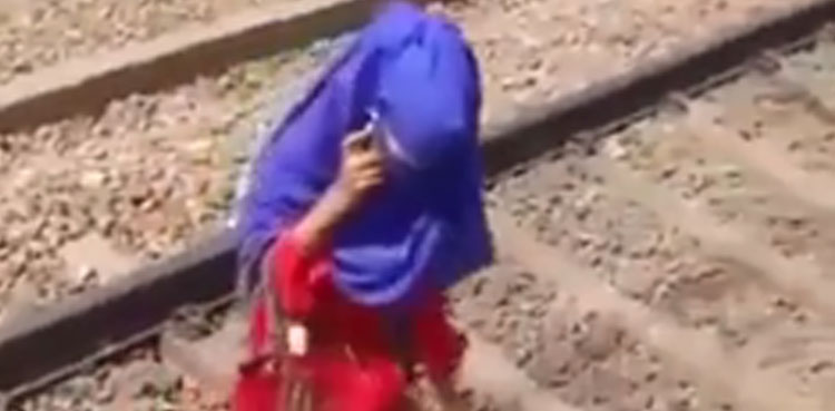 talks on phone, woman, train, passes over