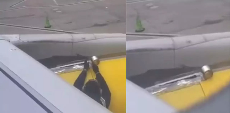 Passenger films, man putting Tape on plane wing, Spirit Airline