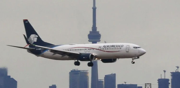 Passenger opens airplane door, walks on wing