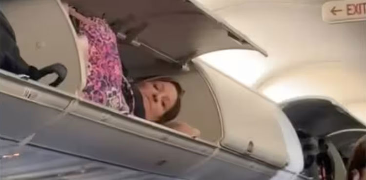 Viral video: Passenger climbs into plane's overhead bin for a nap
