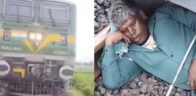 man sleeping on railway track