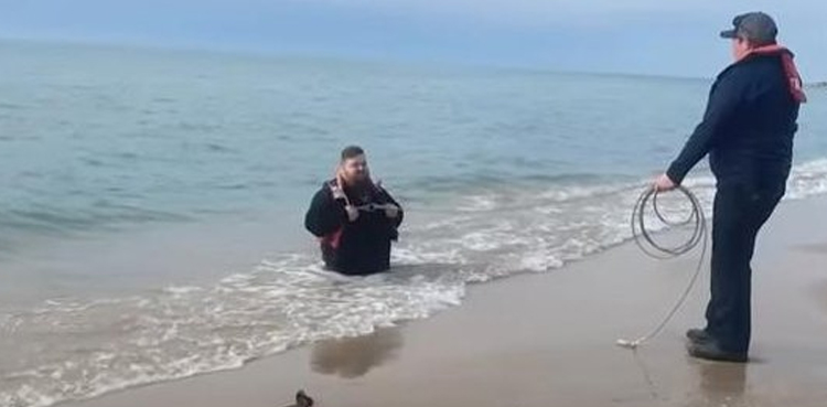 Michigan quicksand rescue, Lake Michigan beach incident, Traverse City news, hydraulic dredging effects